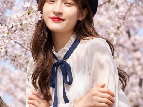 Young Woman in Beret Among Cherry Blossoms